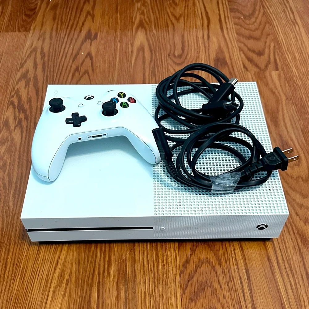 Microsoft xbox one console, controller, and hdmi cable.